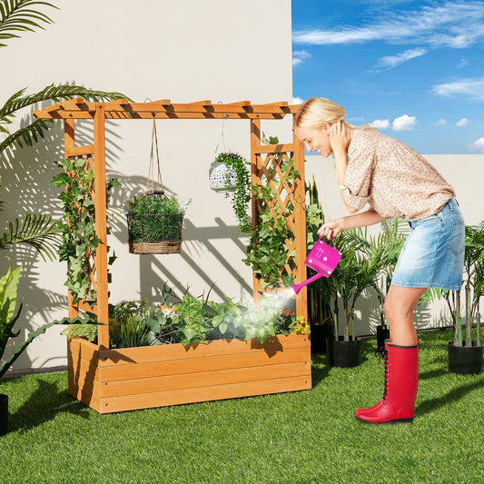 A woman waters plants in the orange raised garden bed with arch trellis on a sunny patio
