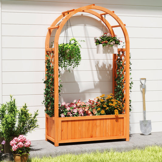 The wooden planter with arch trellis is shown outdoors against a white wall, with a shovel and plants nearby
