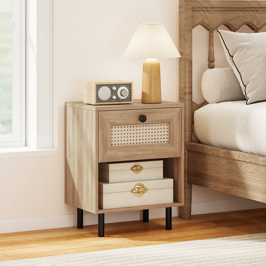 The bedside table is placed next to a bed with a lamp and decorative boxes on top
