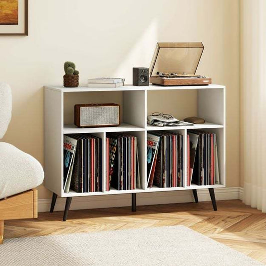 The white record player stand in a living room with a sofa and rug