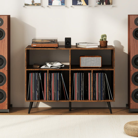 The turntable stand placed between two large speakers with vinyl records stored in the lower shelves