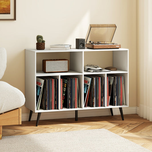 The white record player stand with turntable and speaker on top, shown in a living room setting