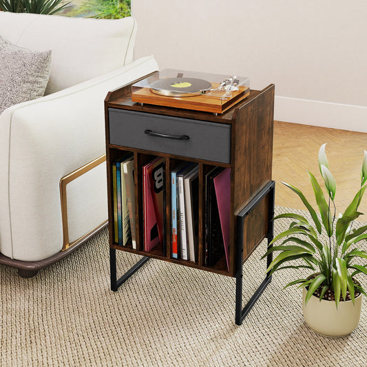 The end table placed next to a white sofa with a turntable and vinyl records inside
