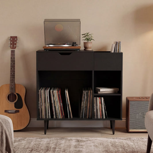 This black record player cabinet is shown in a living room with a guitar and amplifier