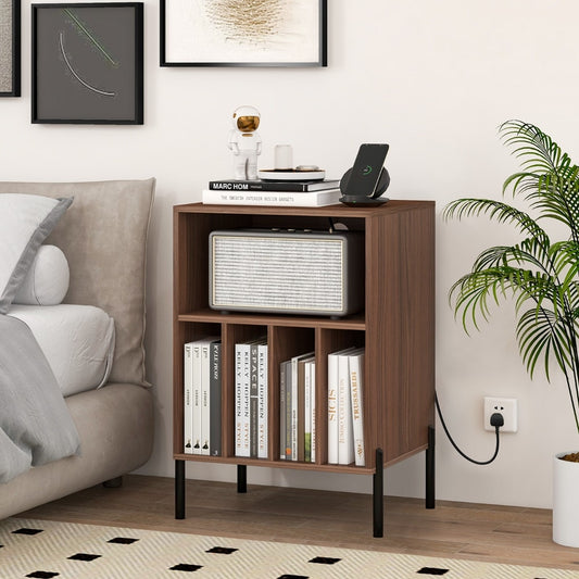 The walnut record player stand next to a bed with books and a speaker on top
