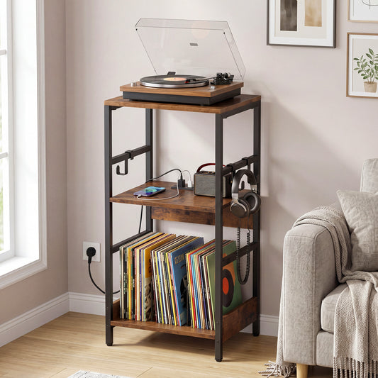 The end table holding a turntable and vinyl records next to a sofa