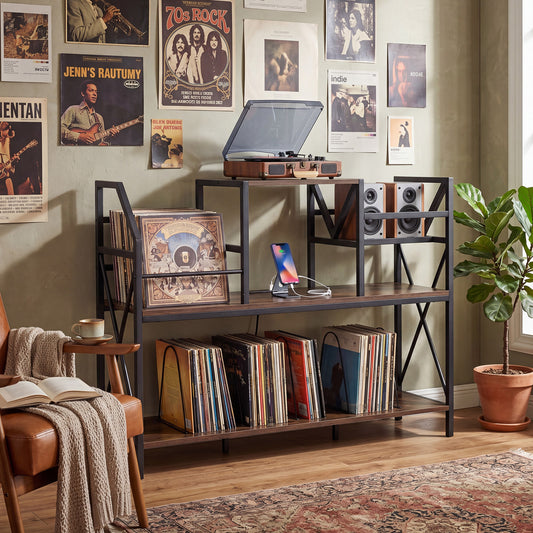 The record player stand in a room with vinyl records, speakers and a turntable set up