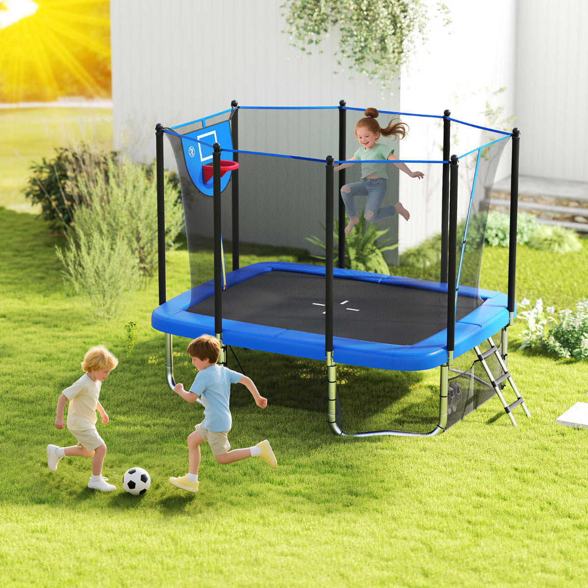 Children playing football and jumping on the blue outdoor trampoline in a garden