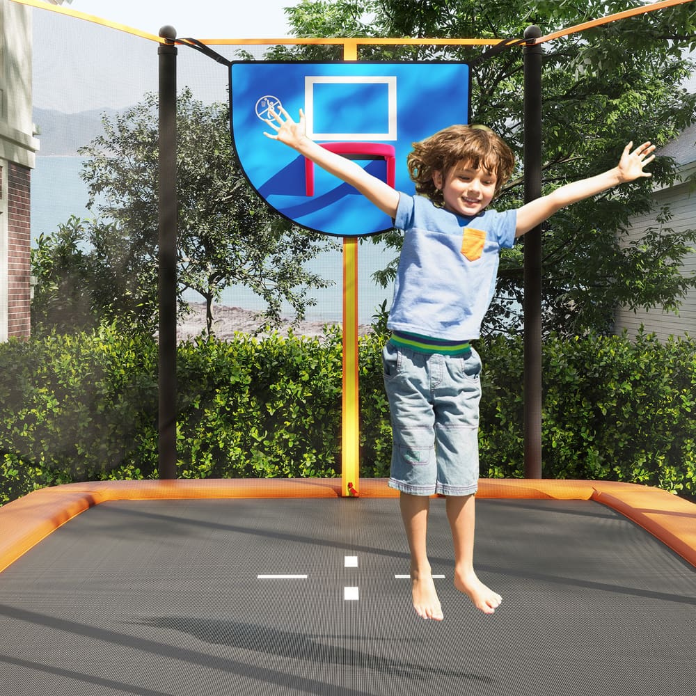 The outdoor trampoline with a happy child jumping high inside the safety enclosure