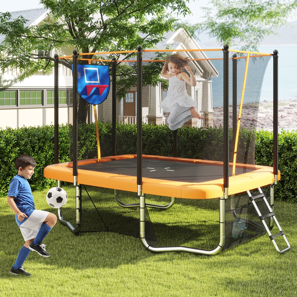The backyard trampoline in a garden with a girl jumping and a boy playing with a football