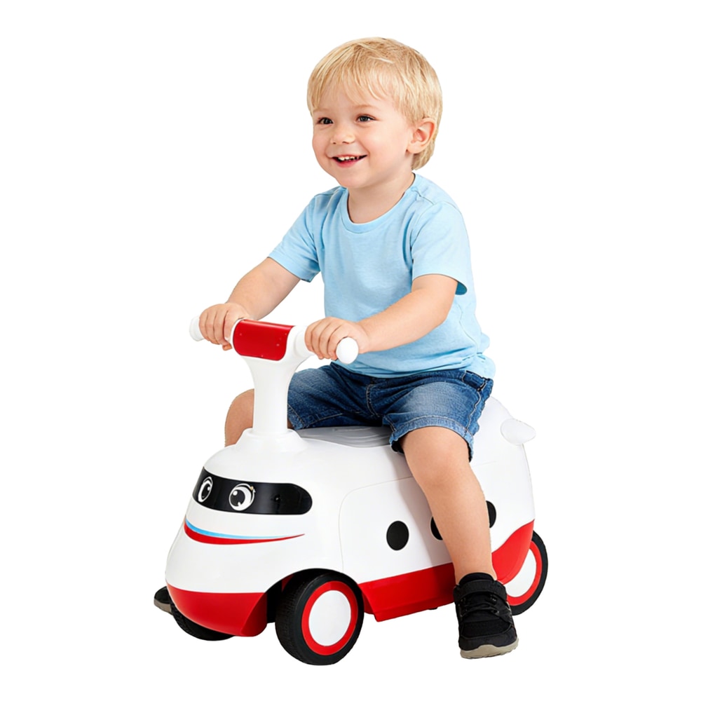 A young boy sits on the white push car with red accents, smiling