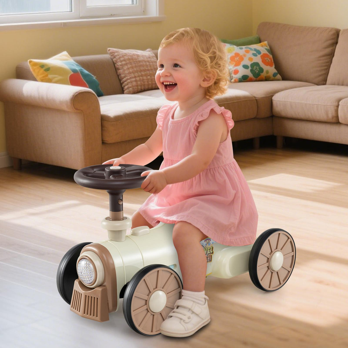 Smiling baby girl in a pink dress riding the beige push car train indoors