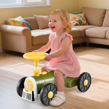 A happy toddler girl in a pink dress rides the green push car train indoors