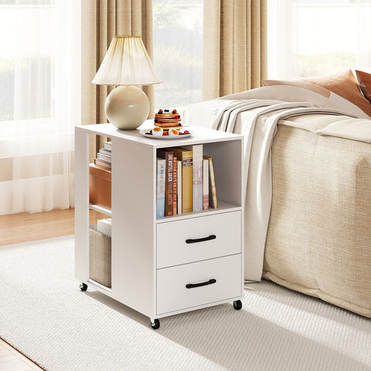 The white nightstand is shown next to a bed with a lamp and books on top