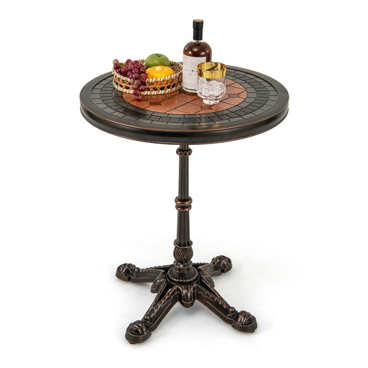 Round Patio Cast Aluminum Dining Table with Carved Texture, bronze finish, with a basket of fruit and a bottle of wine on top
