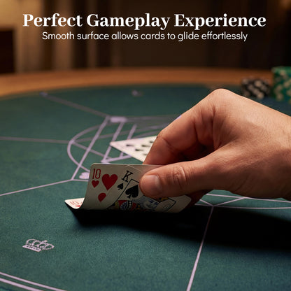 A close view of a hand holding playing cards over the green felt surface of the card table cover