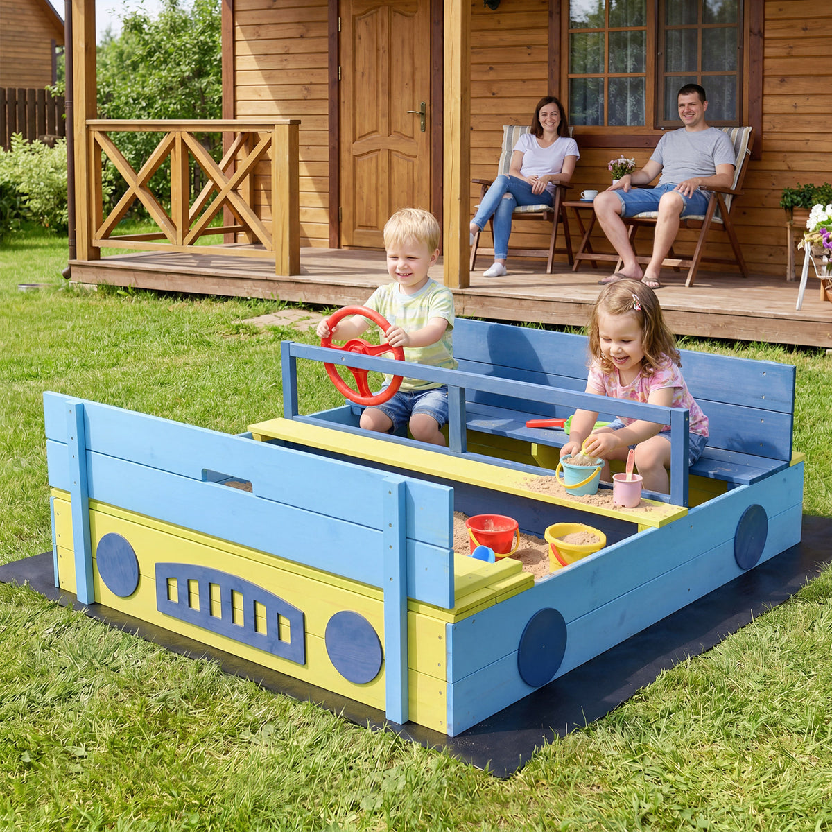 The blue and yellow wooden sandpit with a bench and steering wheel, with two children playing