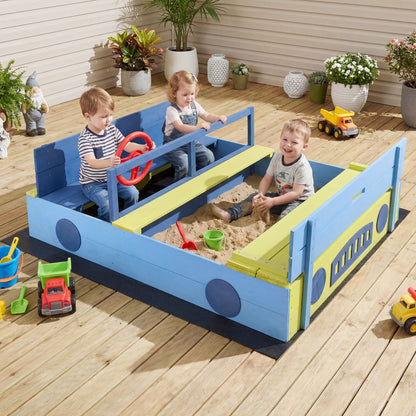 The car shaped sandpit with a bench and steering wheel, with three children playing