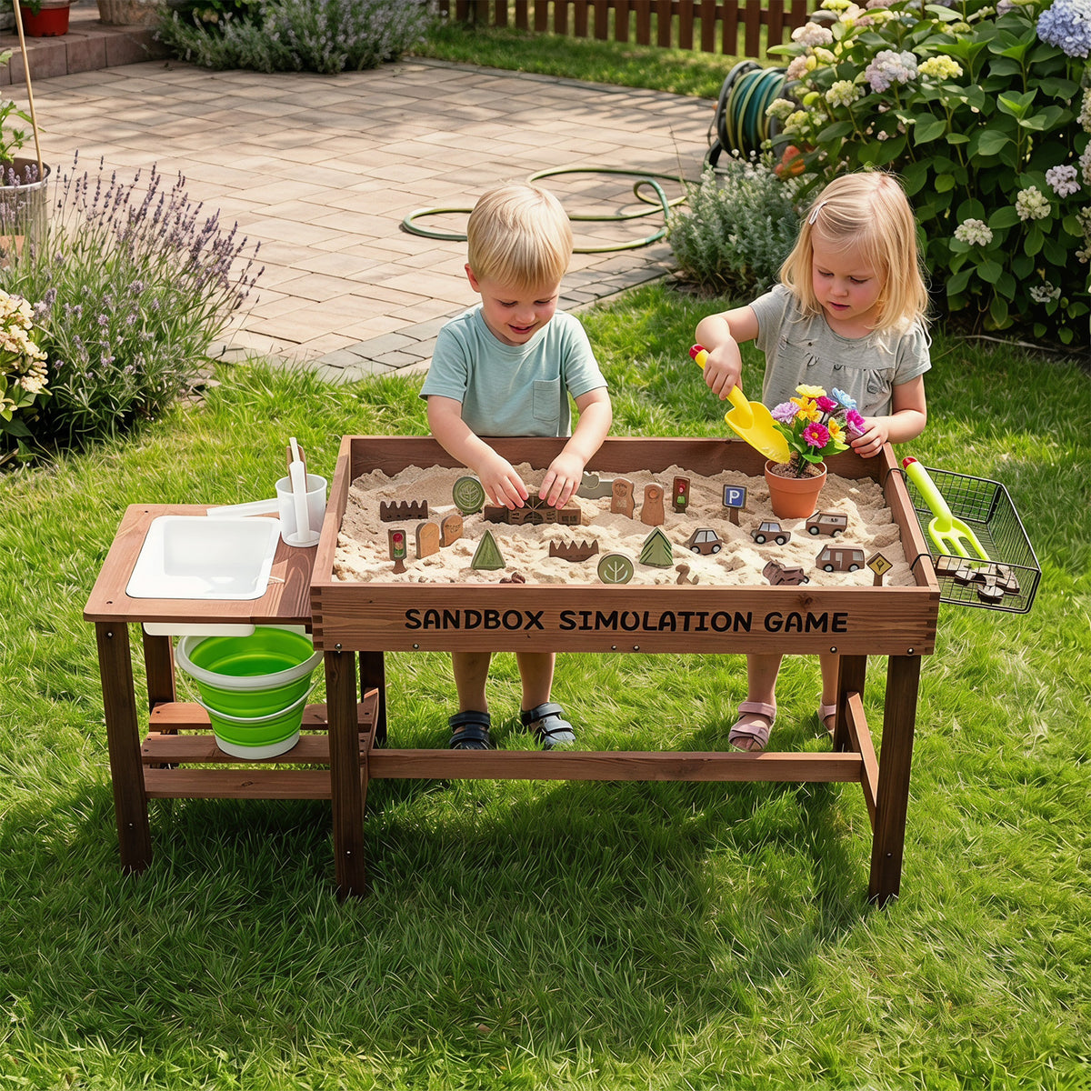 Two young children playing together at the sand table in a garden