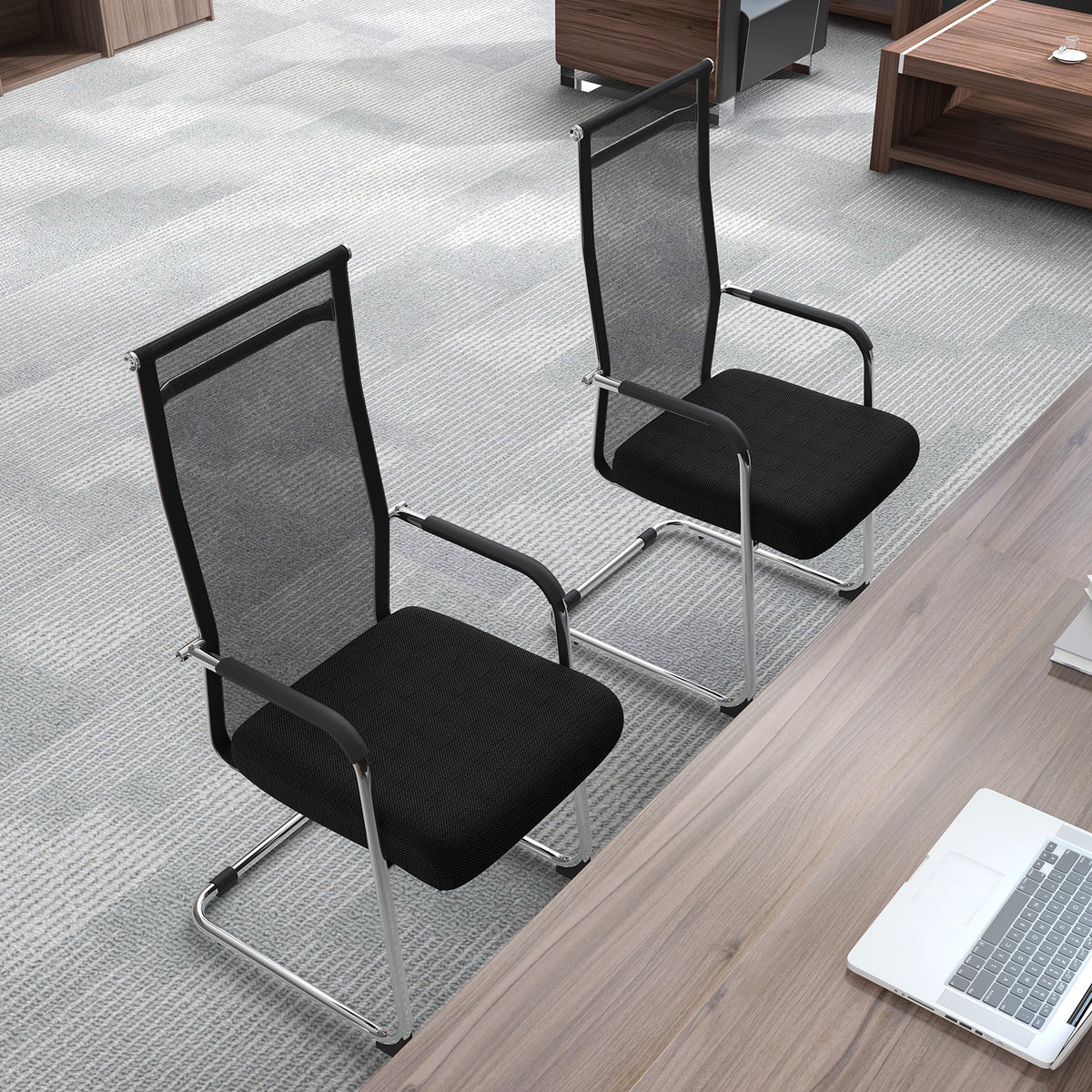Two black office guest chairs with metal sled base and armrests in a modern office setting