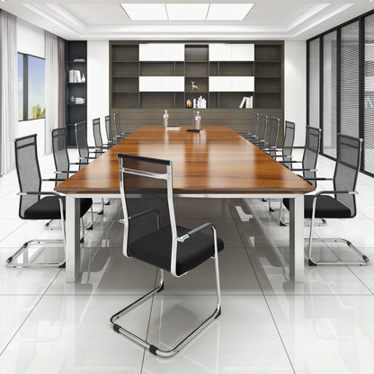 Several black office guest chairs arranged around a large conference table