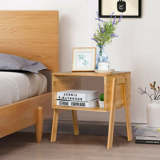 The bedside table placed next to a wooden bed frame with a vase and picture frame on top