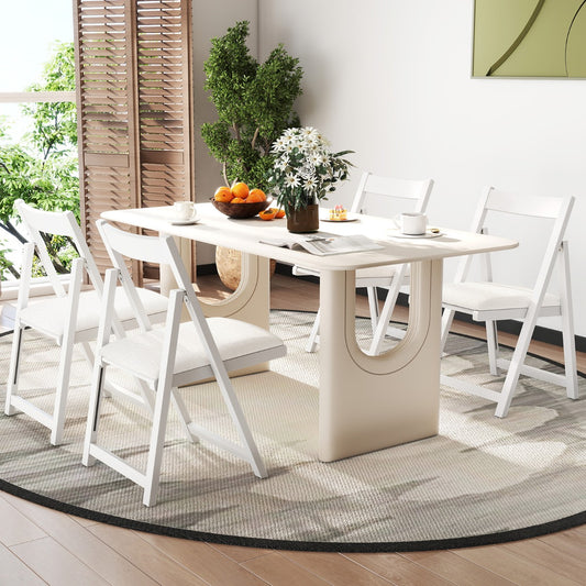 The dining chairs arranged around a modern table in a bright living room setting