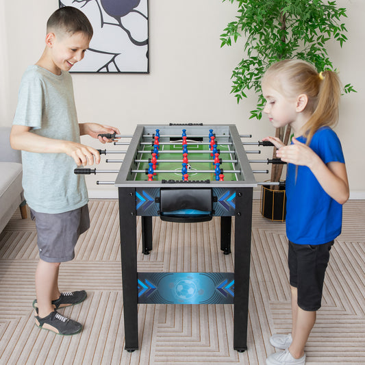 Children playing with the tabletop football game in a living room setting