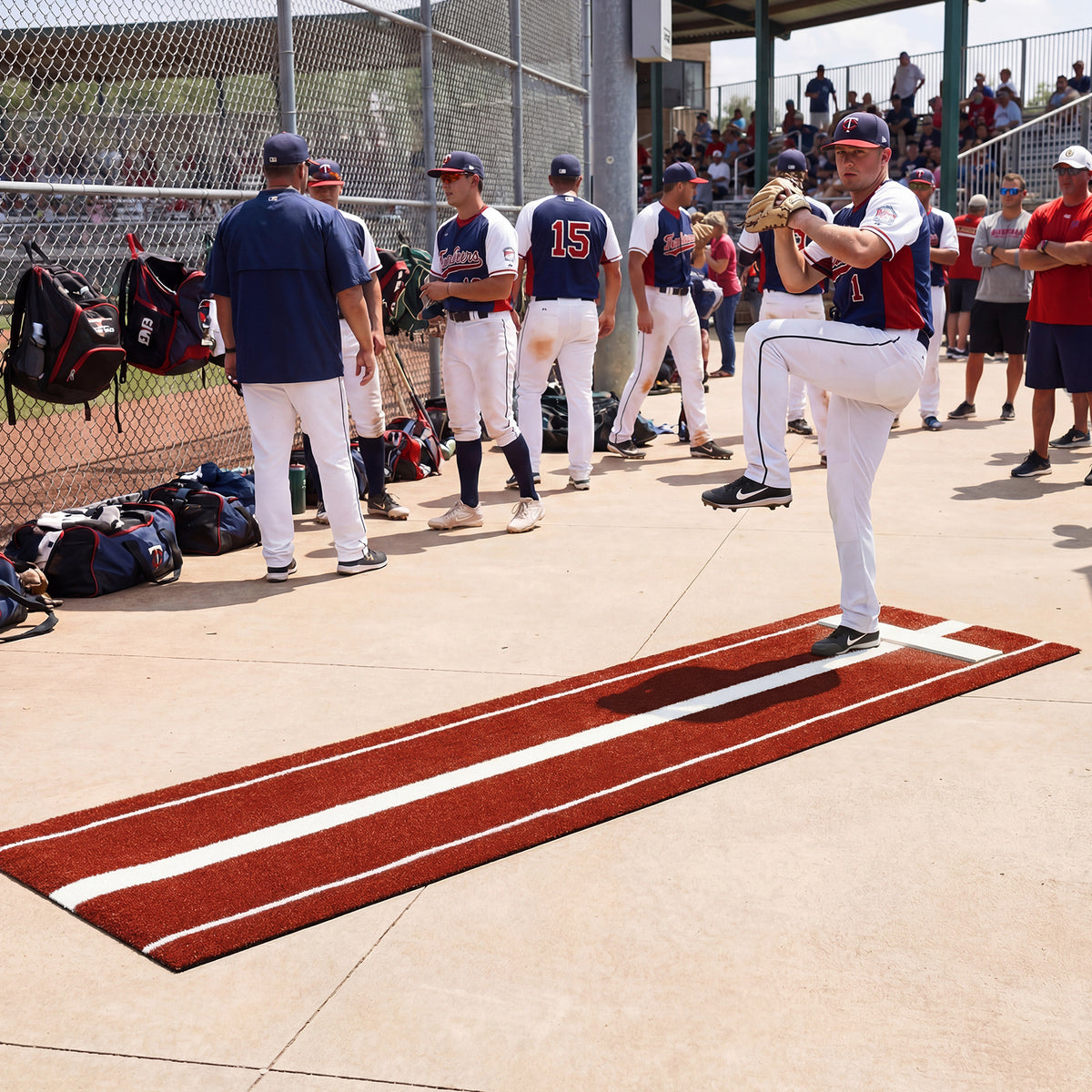 The pitching aid on a concrete surface with players and coaches watching