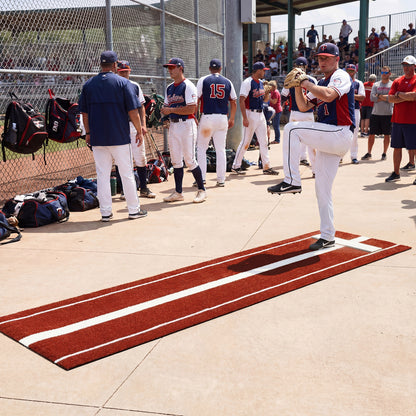 The pitching aid on a concrete surface with players and coaches watching