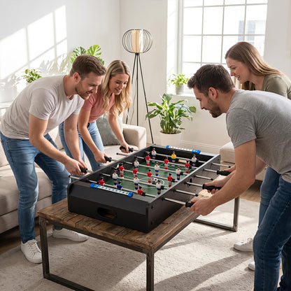 The game room table placed on a wooden coffee table with four people playing
