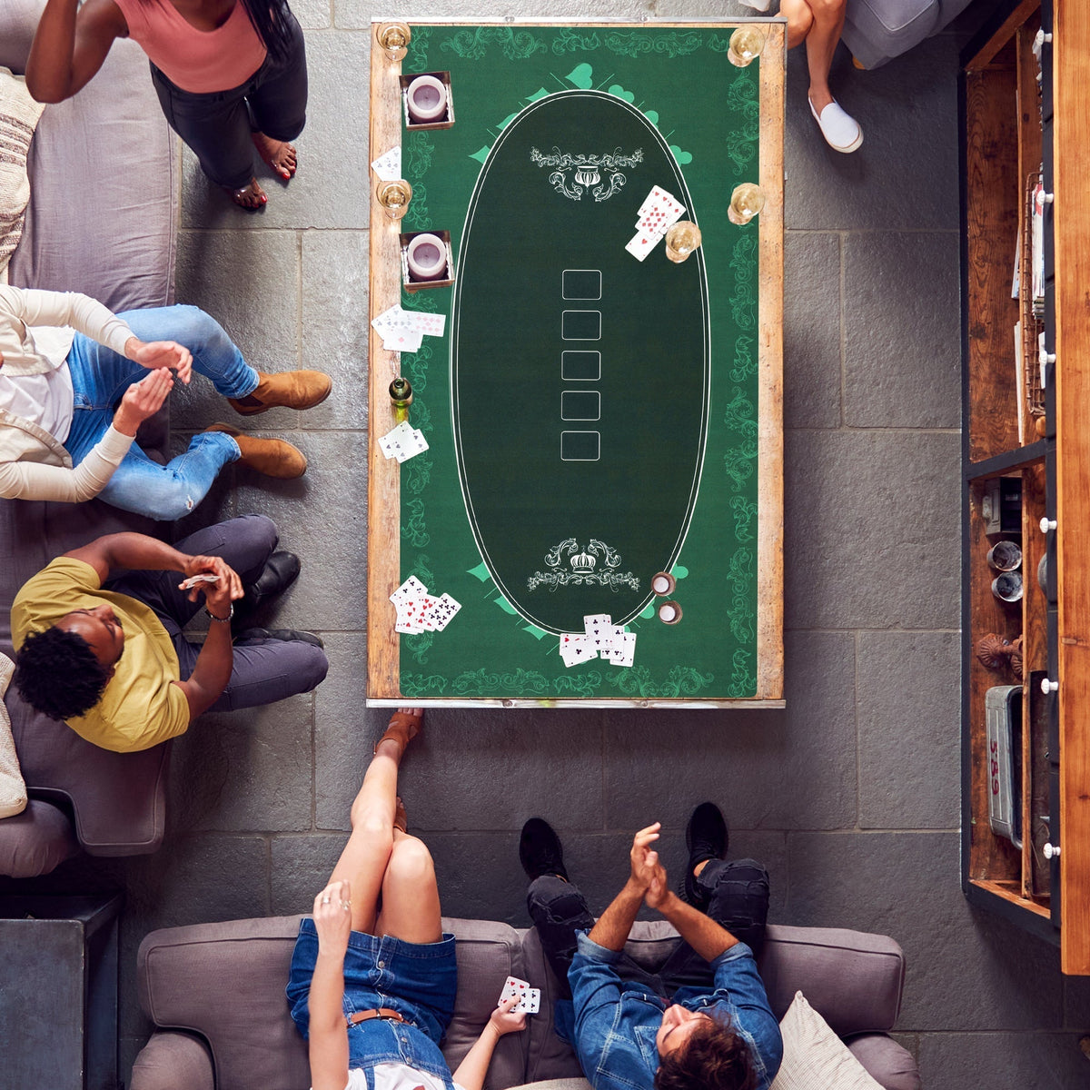 the poker table mat in use with people playing cards around it