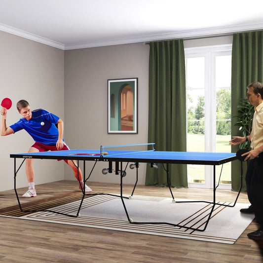 Two men playing tennis on a blue folding table tennis table in a room