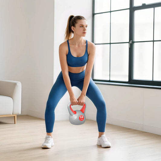 A woman is doing a squat with the red and grey kettlebell