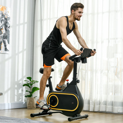 A man in sportswear using the exercise bike in a bright living room setting