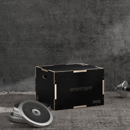 Wooden step up box with weight plates and dumbbell in a gym setting