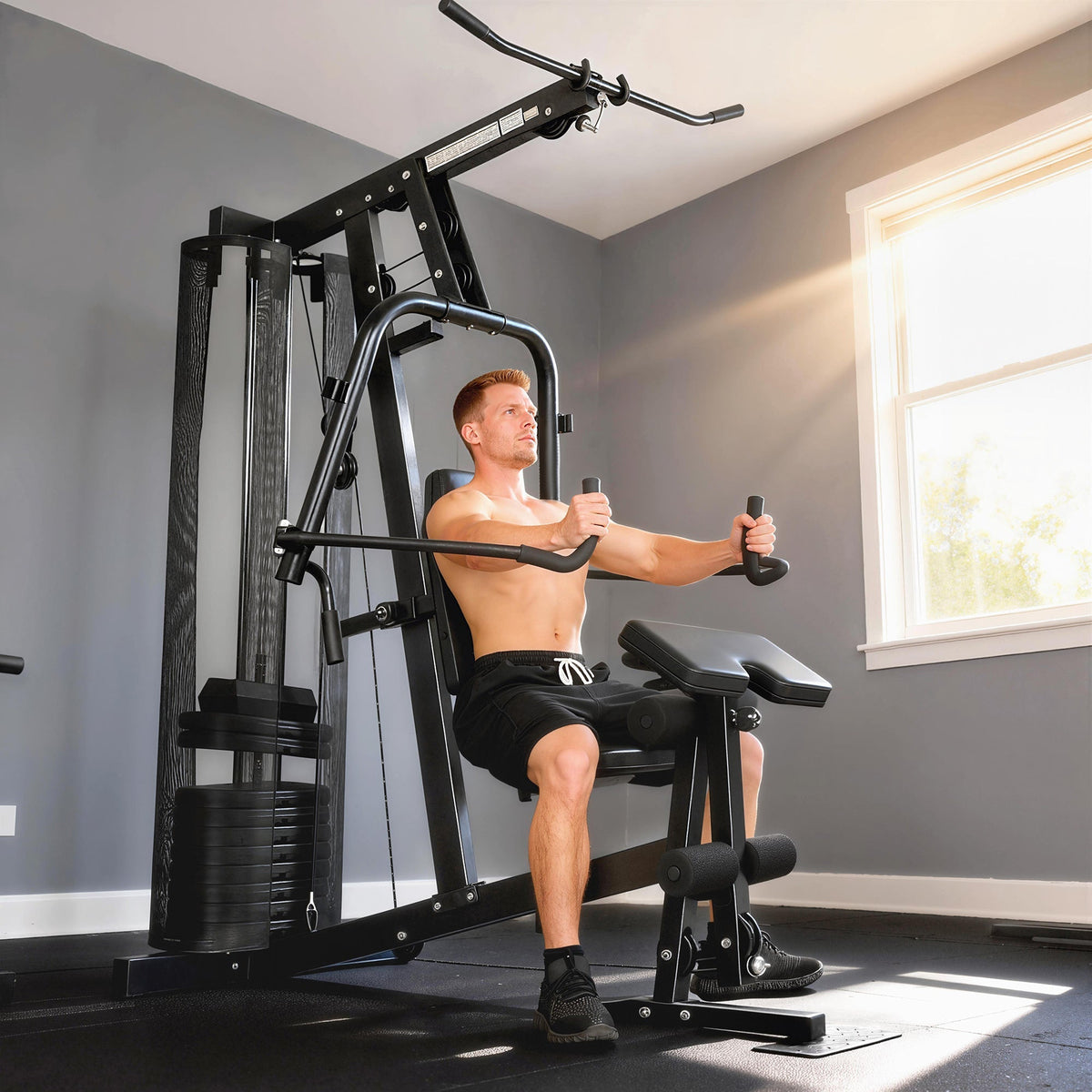 The home gym machine being used by a man for chest exercises in a bright room
