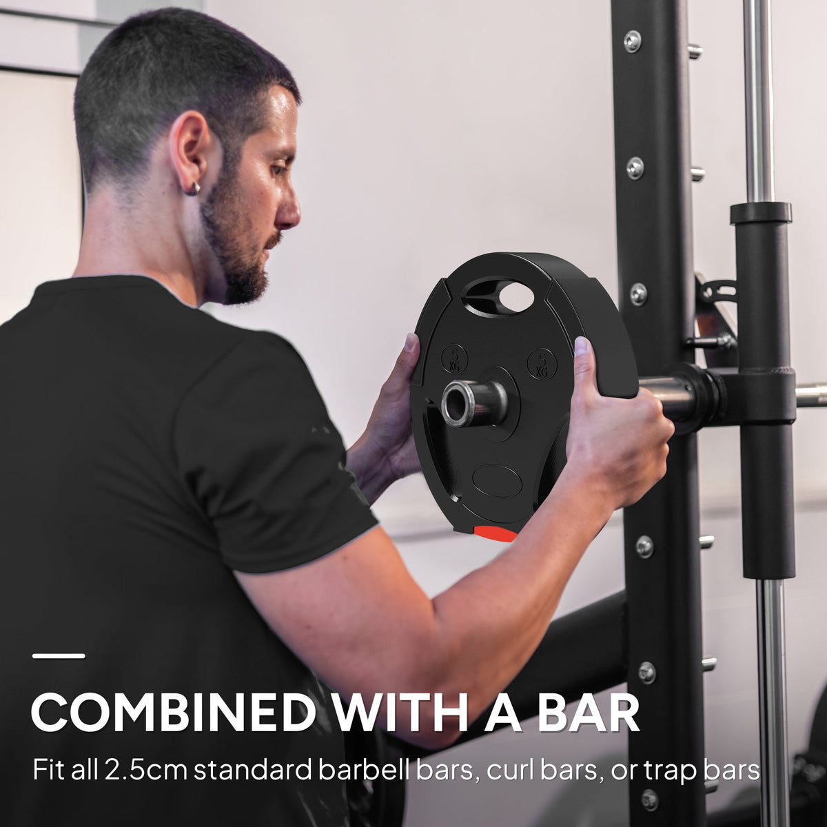 A man attaches a black weight disc with red accents to a barbell