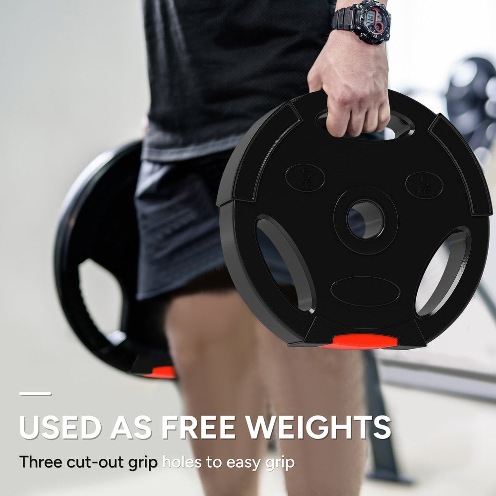 Man holding a black weight plate with red accents, designed for free weights