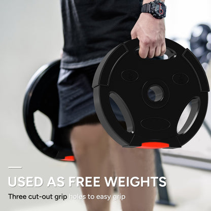 Man holding a black weight plate with red accents, designed for free weights