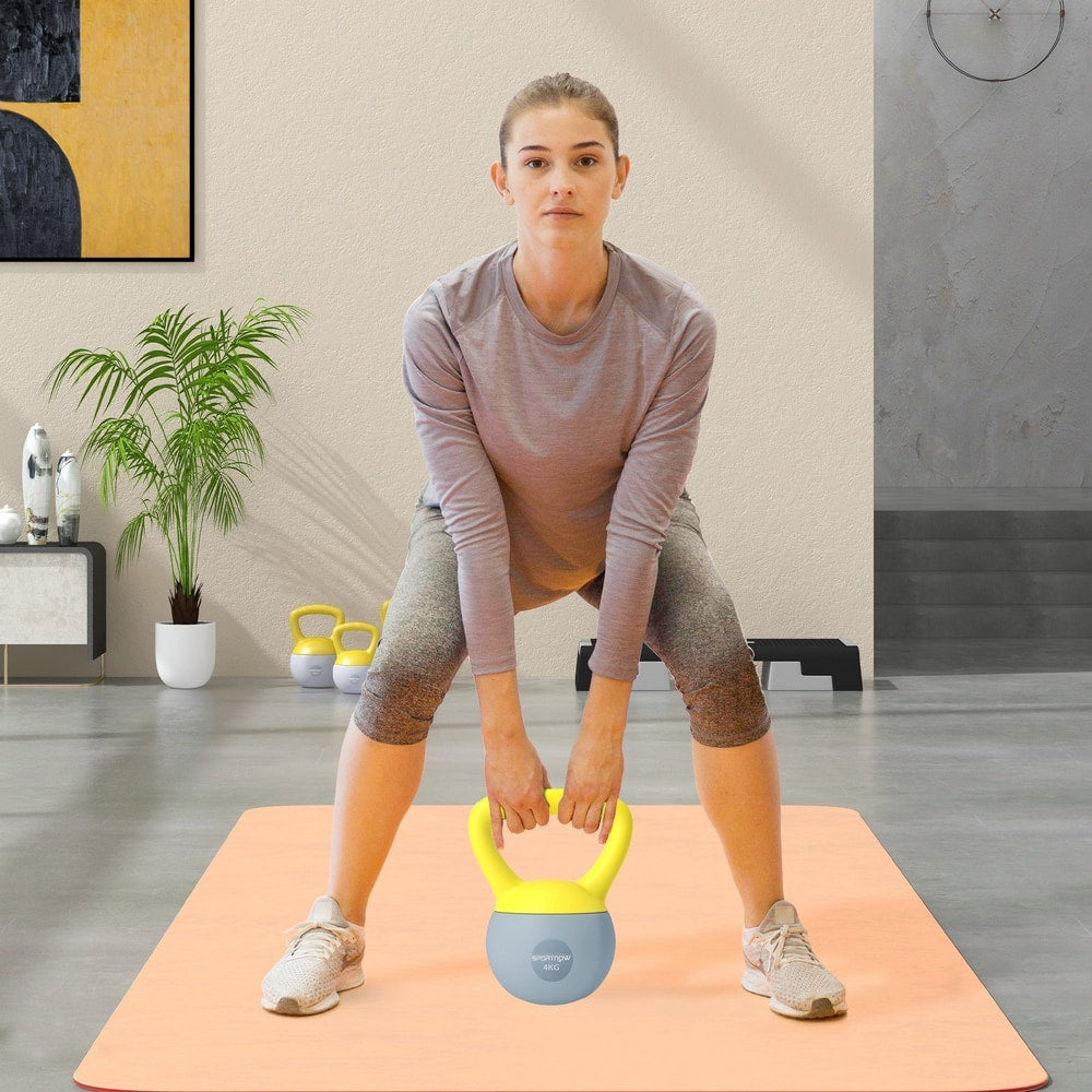 Woman performing a squat exercise with the soft kettlebell in a home gym setting