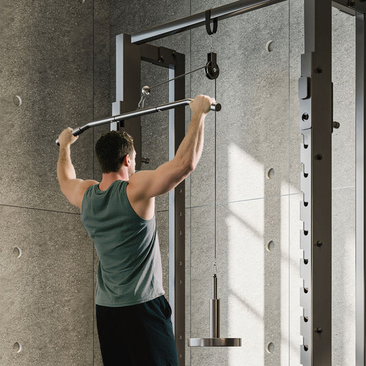 The cable pulley system being used by a man for a lat pull down exercise in a home gym