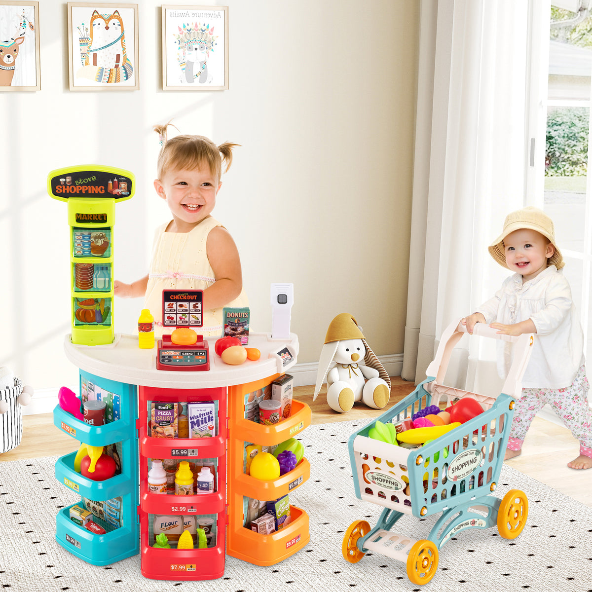 The play kitchen set in a bright room with two children playing with the trolley and shop