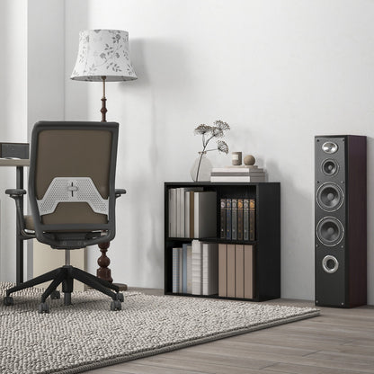 The low bookcase placed in a home office setting next to a desk chair and a tall speaker