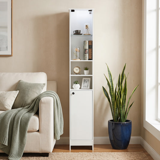 The floor cabinet placed in a living room next to a sofa and a large potted plant