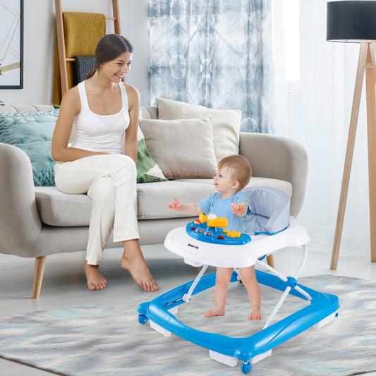 A smiling mother watches her baby in the blue and white baby walker in a living room