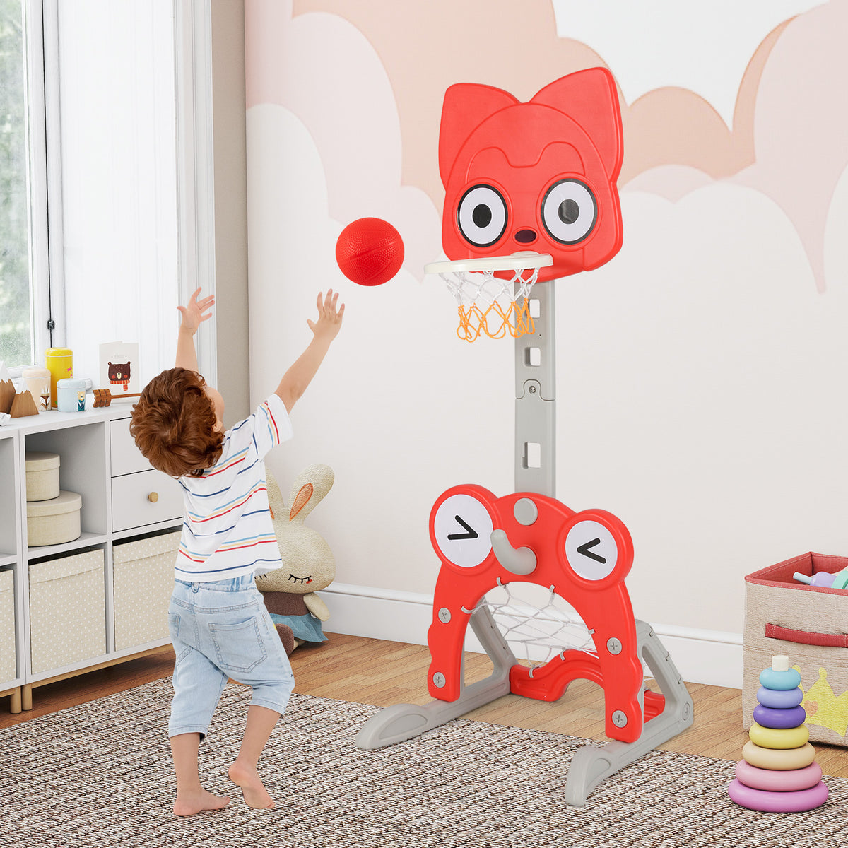 Young boy playing basketball with the toy sports hoop indoors
