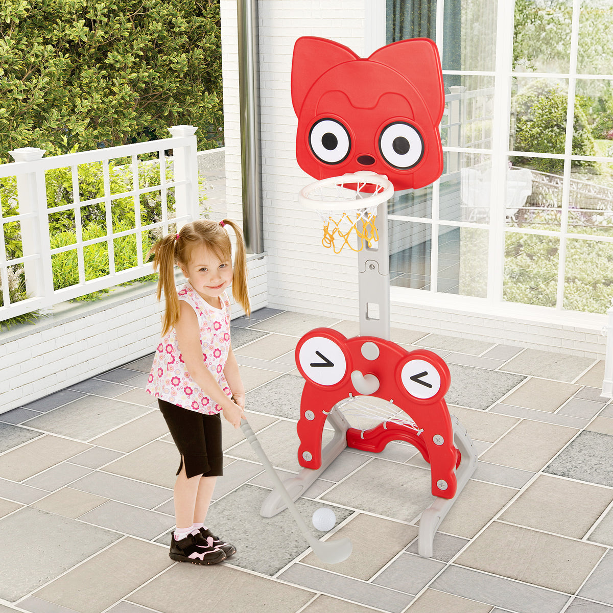 Young girl playing golf with the toy sports hoop outdoors