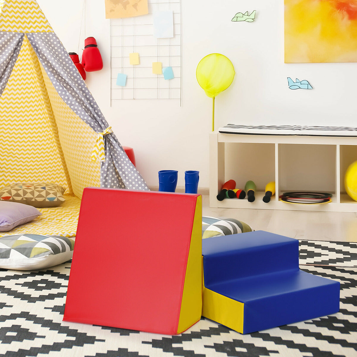The soft play set placed on a patterned rug in a playroom next to a teepee tent