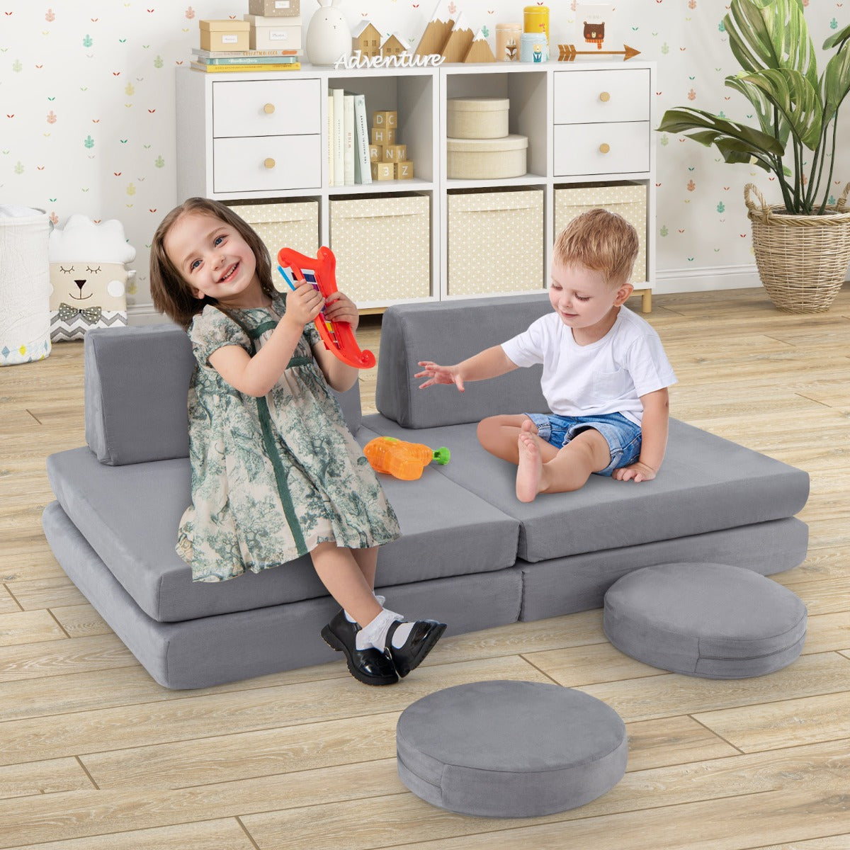 The kids seating set in a playroom with two children playing on the grey foam cushions